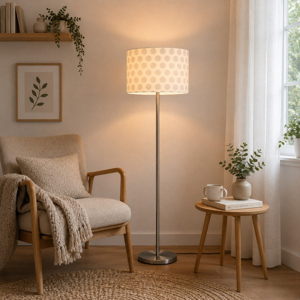 Micasa brushed nickel floor lamp with white fabric shade styled in a Scandinavian reading corner, offering soft ambient lighting for a cozy and minimalist interior