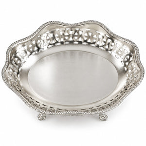 An oval silver serving tray with a scalloped edge, intricate cutout filigree detailing on the sides, and small feet, shown on a white background.