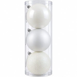 Three white Christmas ornaments in different finishes—matte, glossy, and glitter—stored inside a clear cylindrical plastic container on a white background.
