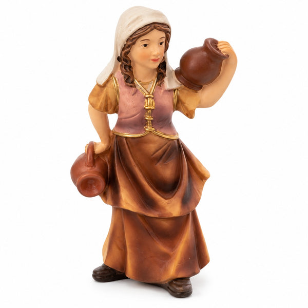 A hand-painted resin figurine of a young girl carrying brown clay pots, dressed in a pink and brown dress with gold trim and a white headscarf, set against a plain white background.