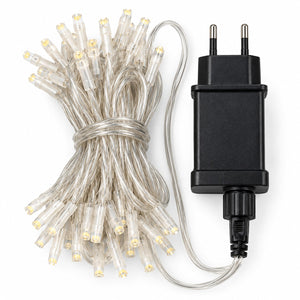 Clear silicone LED fairy string lights bundled with a black two-pin power adapter on a white background.