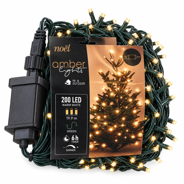 Coiled green outdoor LED string lights with warm white bulbs, shown with a black power adapter and a printed product card featuring a lit Christmas tree.