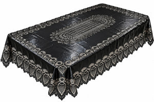 A black tablecloth with an intricate white lace pattern and a scalloped ruffled border, shown from an elevated angle on a white background.