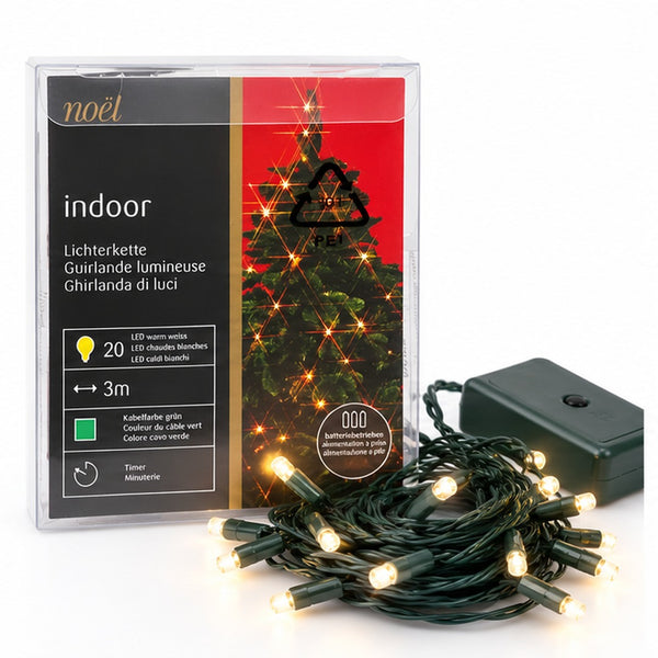 Noél indoor Christmas string lights in a clear plastic package, shown with a coiled bundle of warm white LED lights and a black power adapter on a white background.