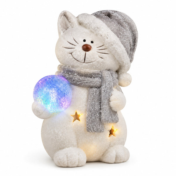 A snowman-shaped cat figurine wearing a gray hat and scarf, holding a glowing multicolor orb, with small star cutouts on its belly, photographed on a clean white background.