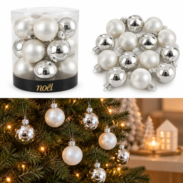 White and silver Christmas ornament set shown in a clear cylindrical container with a black base labeled 'noël', plus a loose pile of the ornaments and a lifestyle scene hanging them on a decorated Christmas tree.