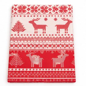 Red and white Christmas-themed fabric featuring knit-style patterns with reindeer, Christmas trees, snowflakes, and geometric borders.