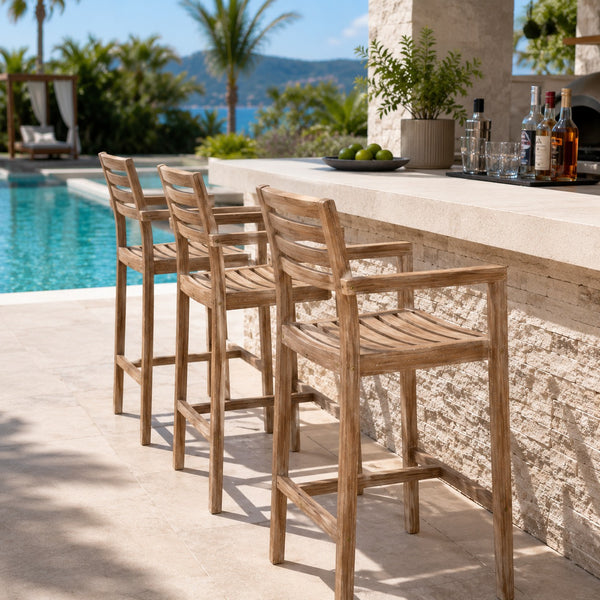 Migros solid wood outdoor bar chairs beside a luxury poolside bar.