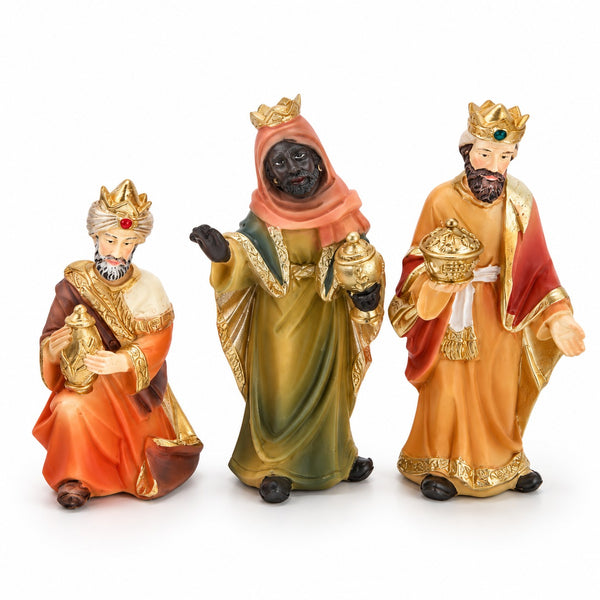 Three Christmas nativity figurines of the Three Wise Men standing side by side on a white background.