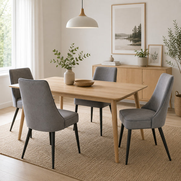 Grey upholstered dining chairs styled in a bright Scandinavian dining room with a natural wood dining table.