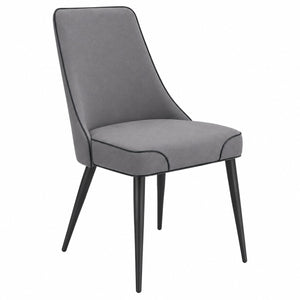 Three-quarter view of the modern grey upholstered dining chair with soft fabric upholstery and black metal legs
