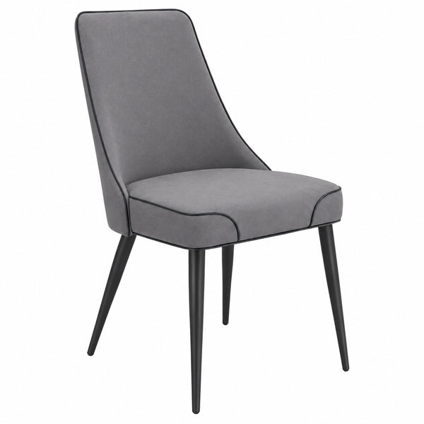 Three-quarter view of the modern grey upholstered dining chair with soft fabric upholstery and black metal legs
