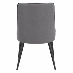 Rear view of the modern grey upholstered dining chair with black metal legs