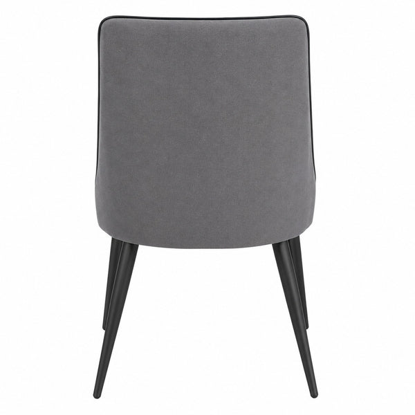 Rear view of the modern grey upholstered dining chair with black metal legs