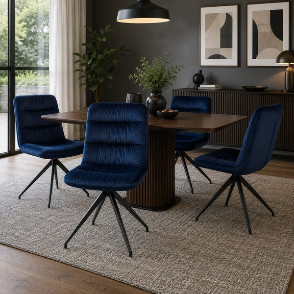 Scandinavian dining room furnished with navy velvet swivel dining chairs.