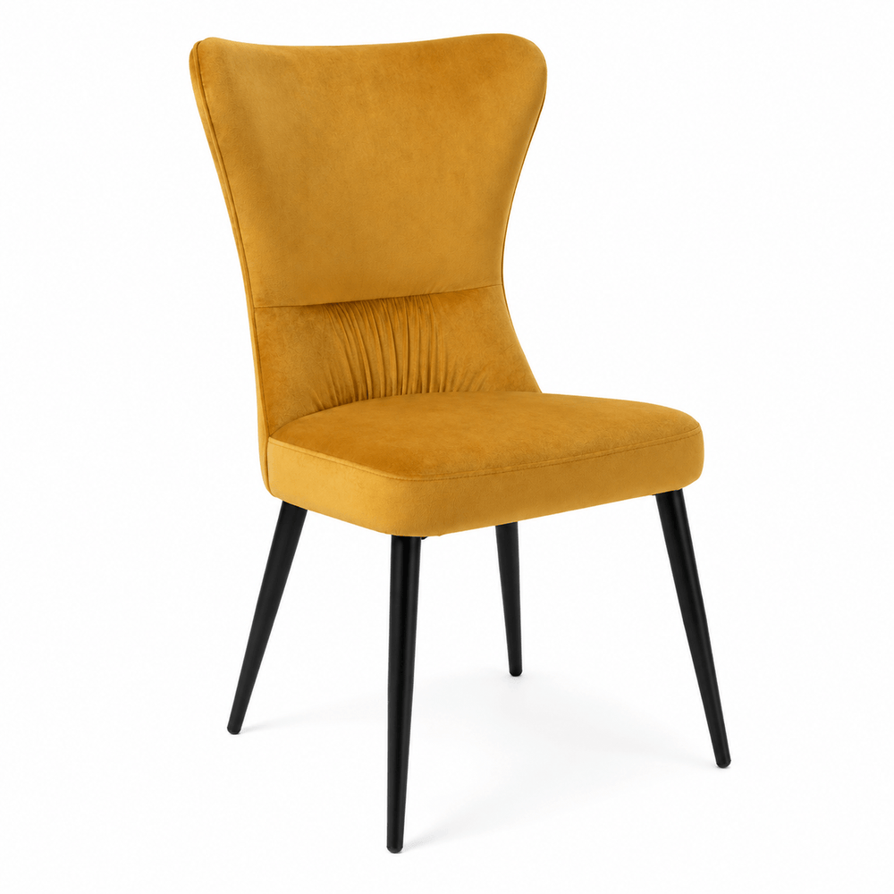 Mustard and Charcoal velvet dining chairs displayed together around a modern dining table.