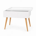 A modern white storage table with a lift-top tray and tapered light wood legs, shown on a clean white background.