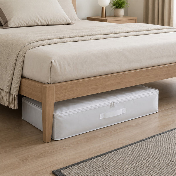 Ordinett Top Class white underbed storage bag neatly placed beneath a modern wooden bed, providing space-saving storage for blankets, bedding, seasonal clothing, and household linens.