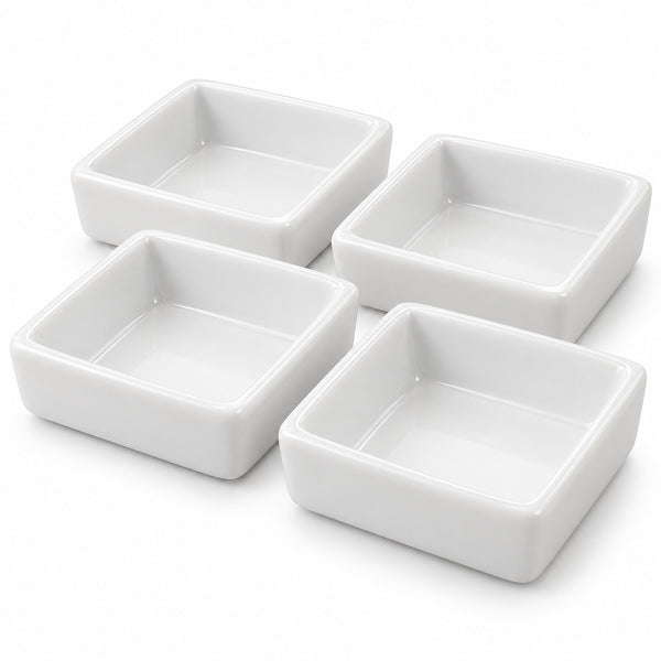 Four white square ceramic bowls arranged in a 2x2 grid on a clean white background.