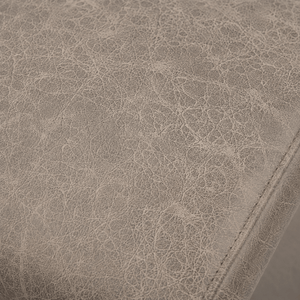 Close-up of the vintage taupe distressed leather-look upholstery texture