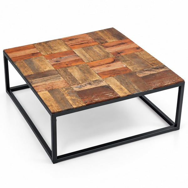 A square coffee table with a rustic patchwork wood top made of varied brown and orange-toned reclaimed wood planks, supported by a black metal frame on a white background.