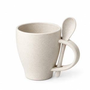 A light beige speckled ceramic mug with a handle shaped like a spoon, shown on a clean white background.