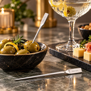 stainless steel cocktail picks with olives and appetizers in an elegant cocktail setting