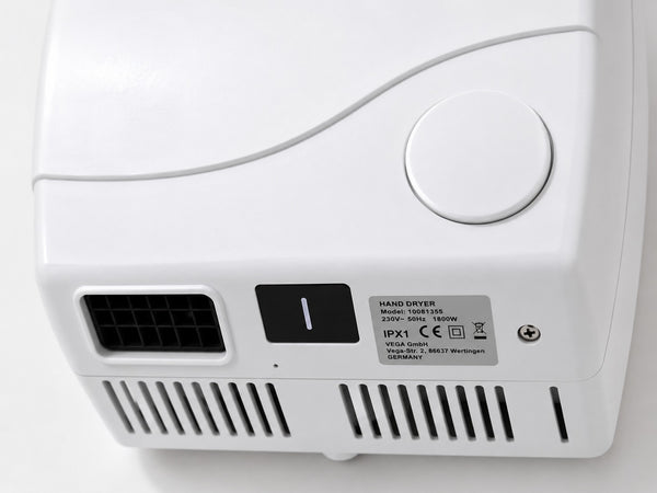 Close-up of VEGA hand dryer air outlet and push button