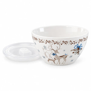 A white ceramic bowl with a lid, decorated with a winter holiday pattern featuring brown deer, blue bows, and brown leafy branches, shown on a white background.